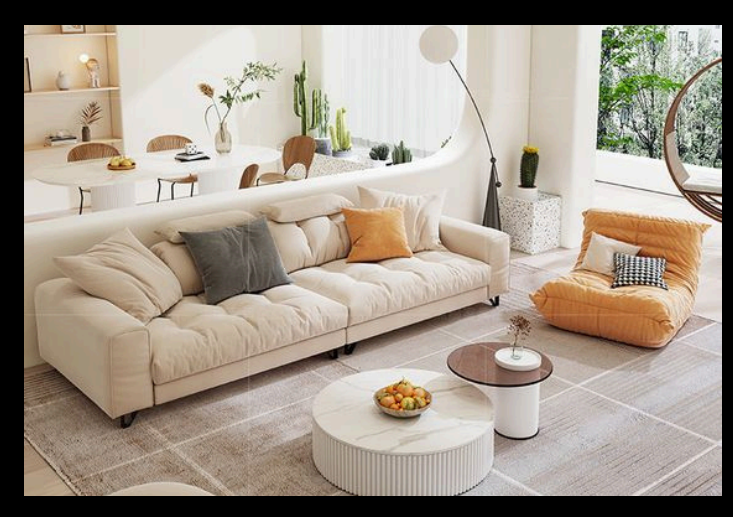 Living room with a beige sofa, pillows, and a coffee table